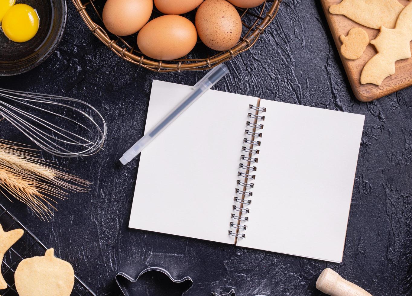 Making cookies cookbook recipe design concept, baking ingredients preparation layout with notebook, top view, flat lay, overhead, mockup copy space. photo