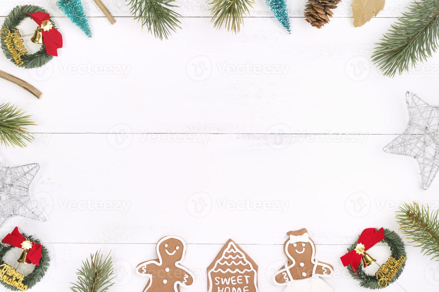 Christmas concept composition decoration objects, fir tree branch wreath, gingerbread man biscuit isolated on white wooden table, top view, flat lay photo