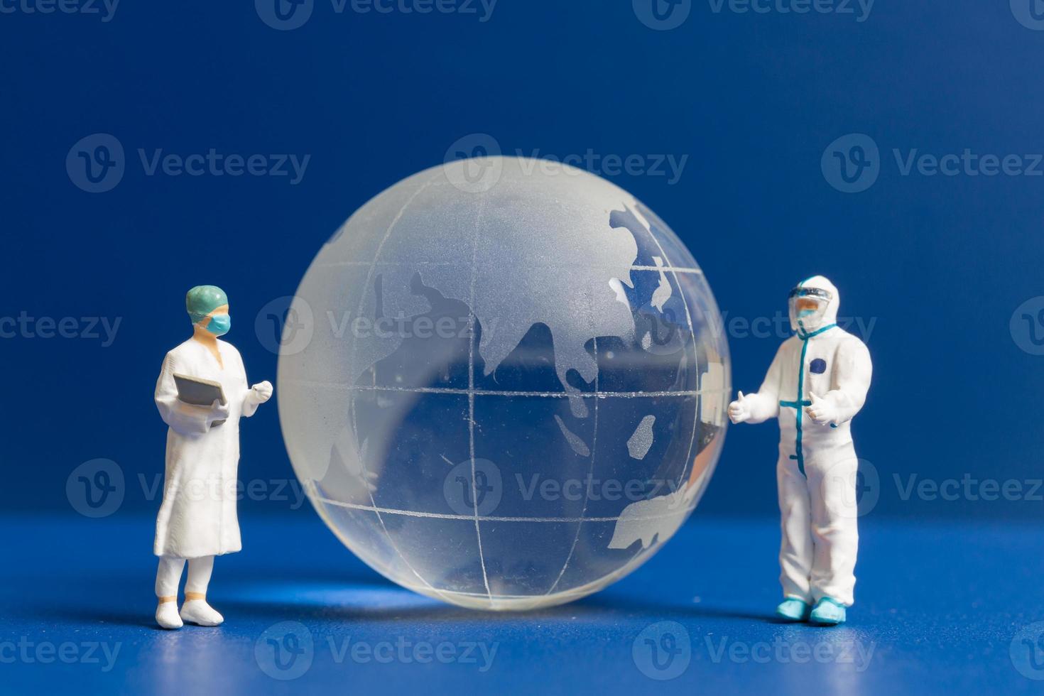Miniature people Doctor and nurse checking global health care photo