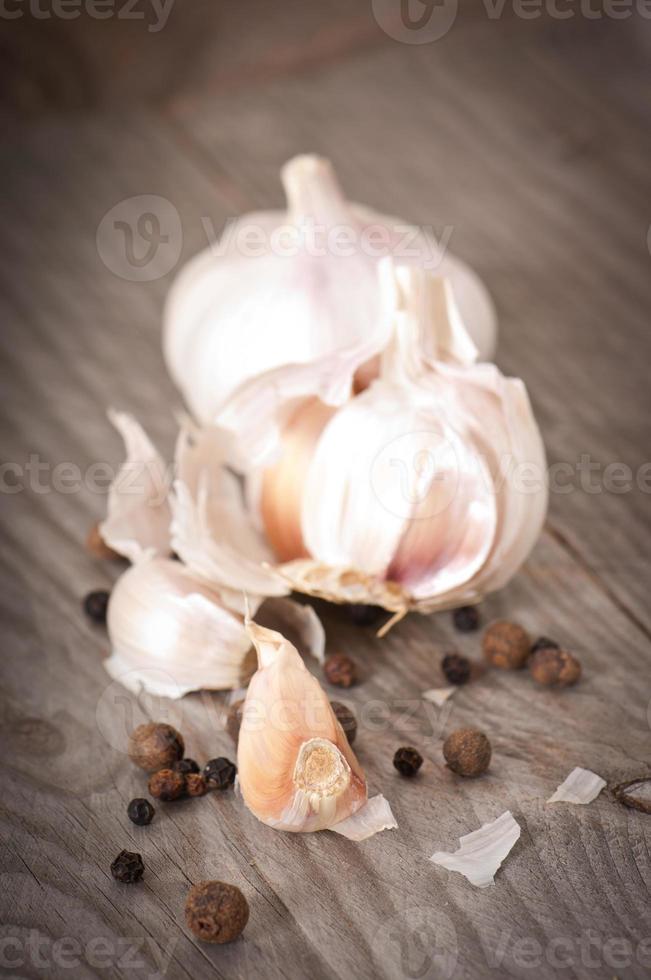 garlic and pepper on a wooden background photo