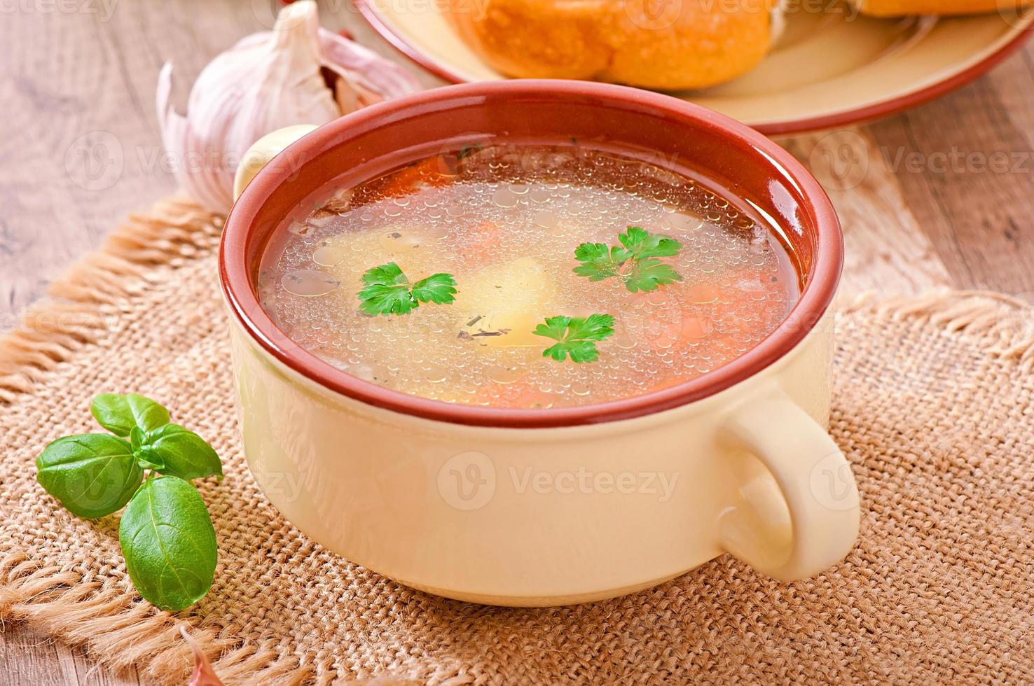 Chicken soup in the brown ceramic bowl photo