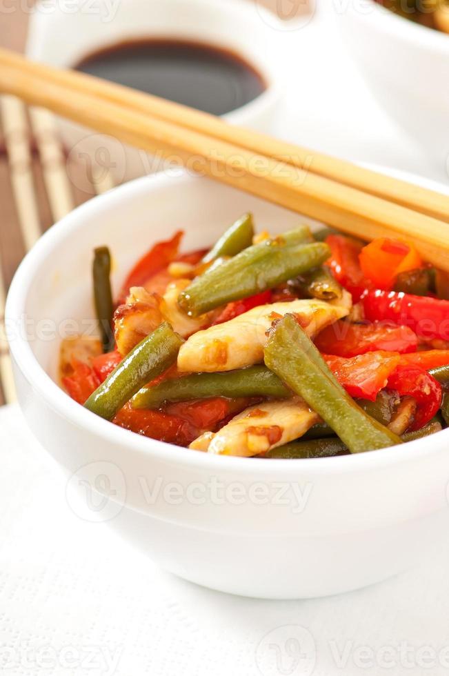 Chicken breast with vegetables and sauce decorated with basil leaves photo