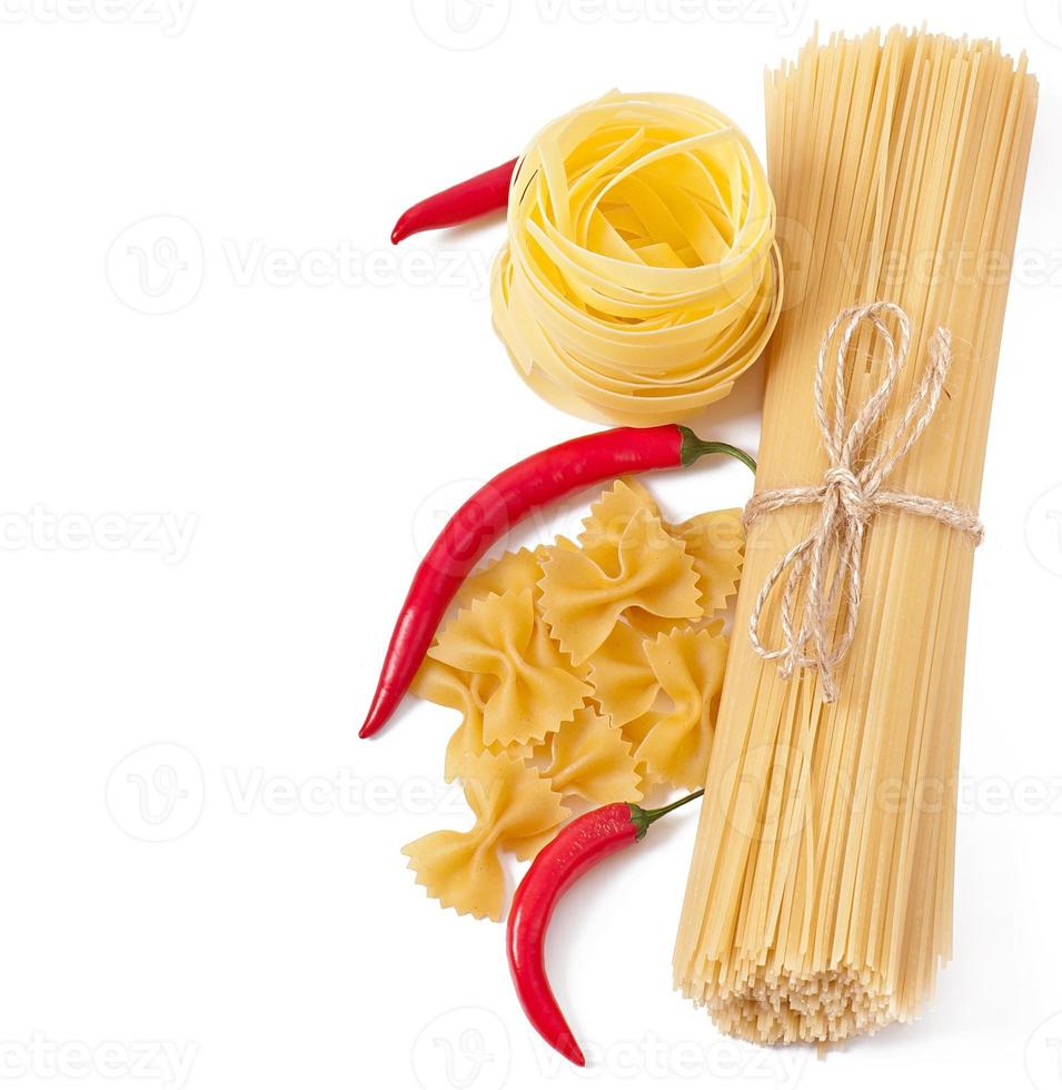 Pasta spaghetti, vegetables, spices isolated on white photo