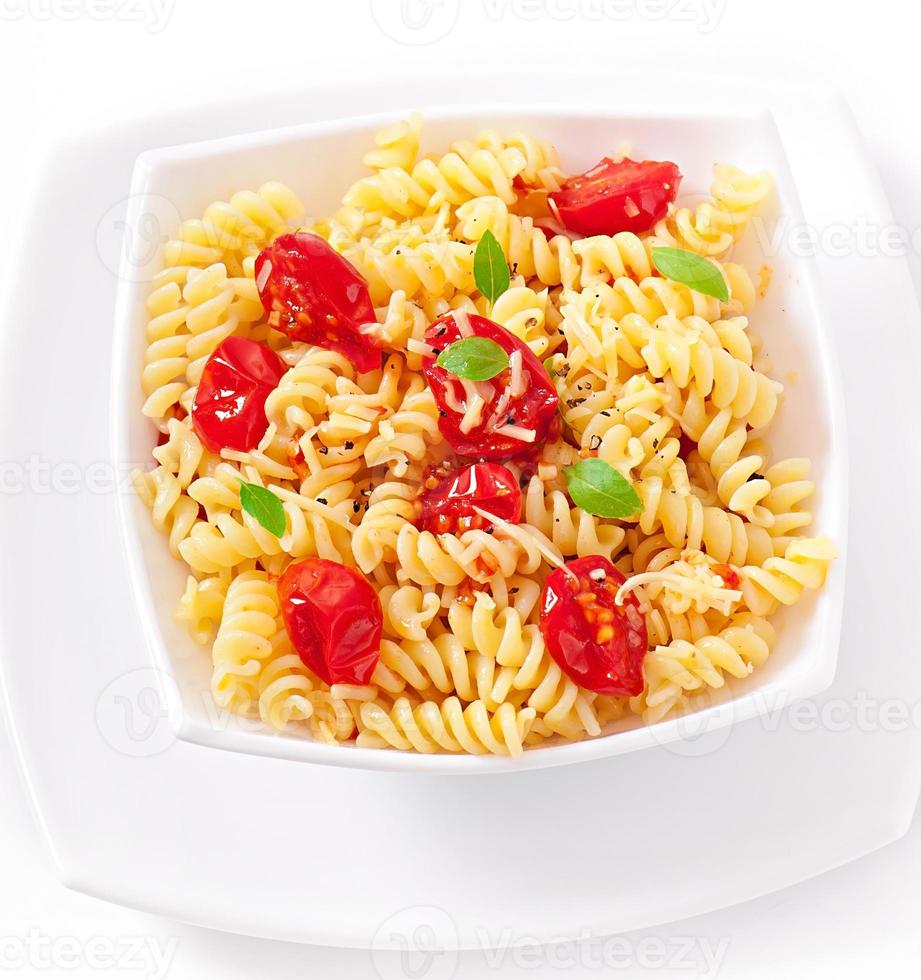 pasta with tomato, basil and grated cheese photo