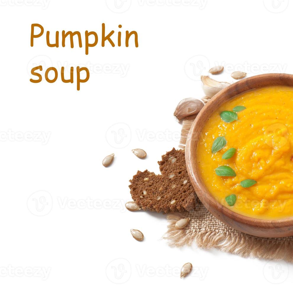 Cream of pumpkin soup in a wooden bowl photo