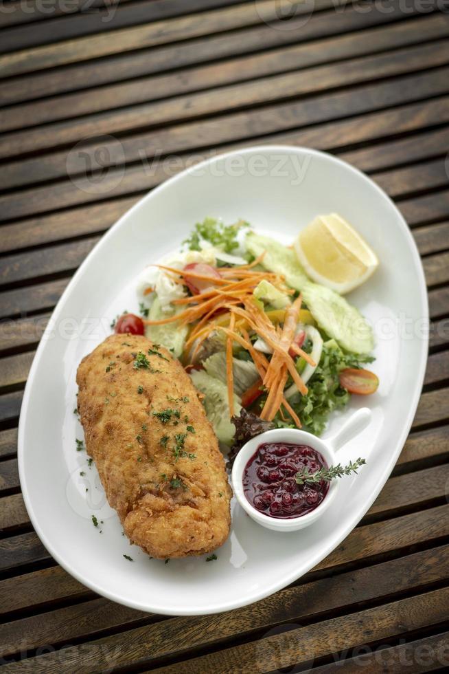 chicken cordon bleu meal with salad in french restaurant photo