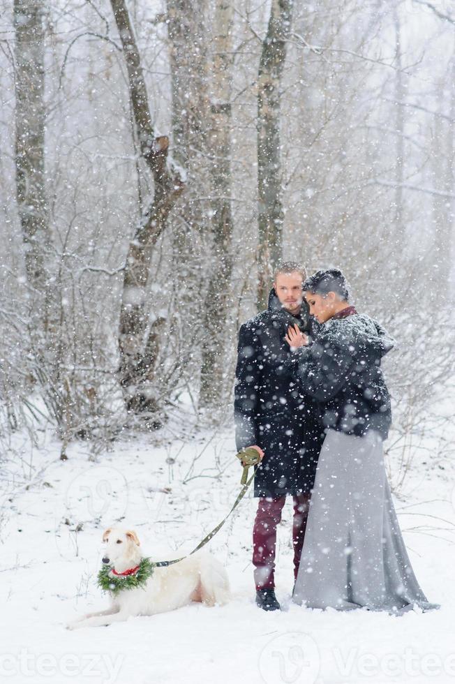 Winter walk in a snowstorm with a dog photo