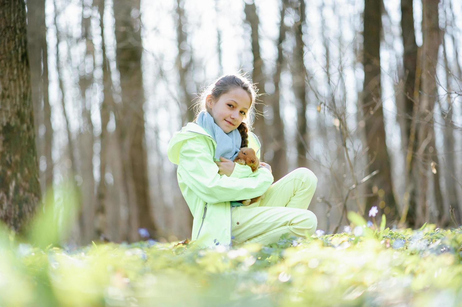 Little girl with a rabbit photo