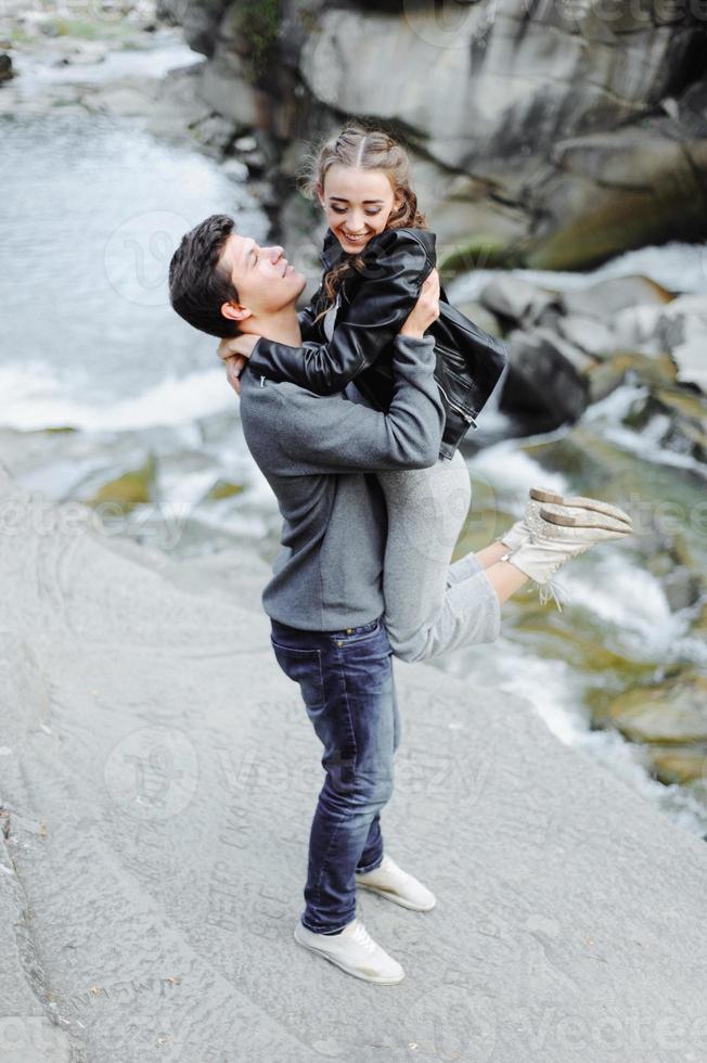 incredibly beautiful and lovely couple on the background of a mountain river photo