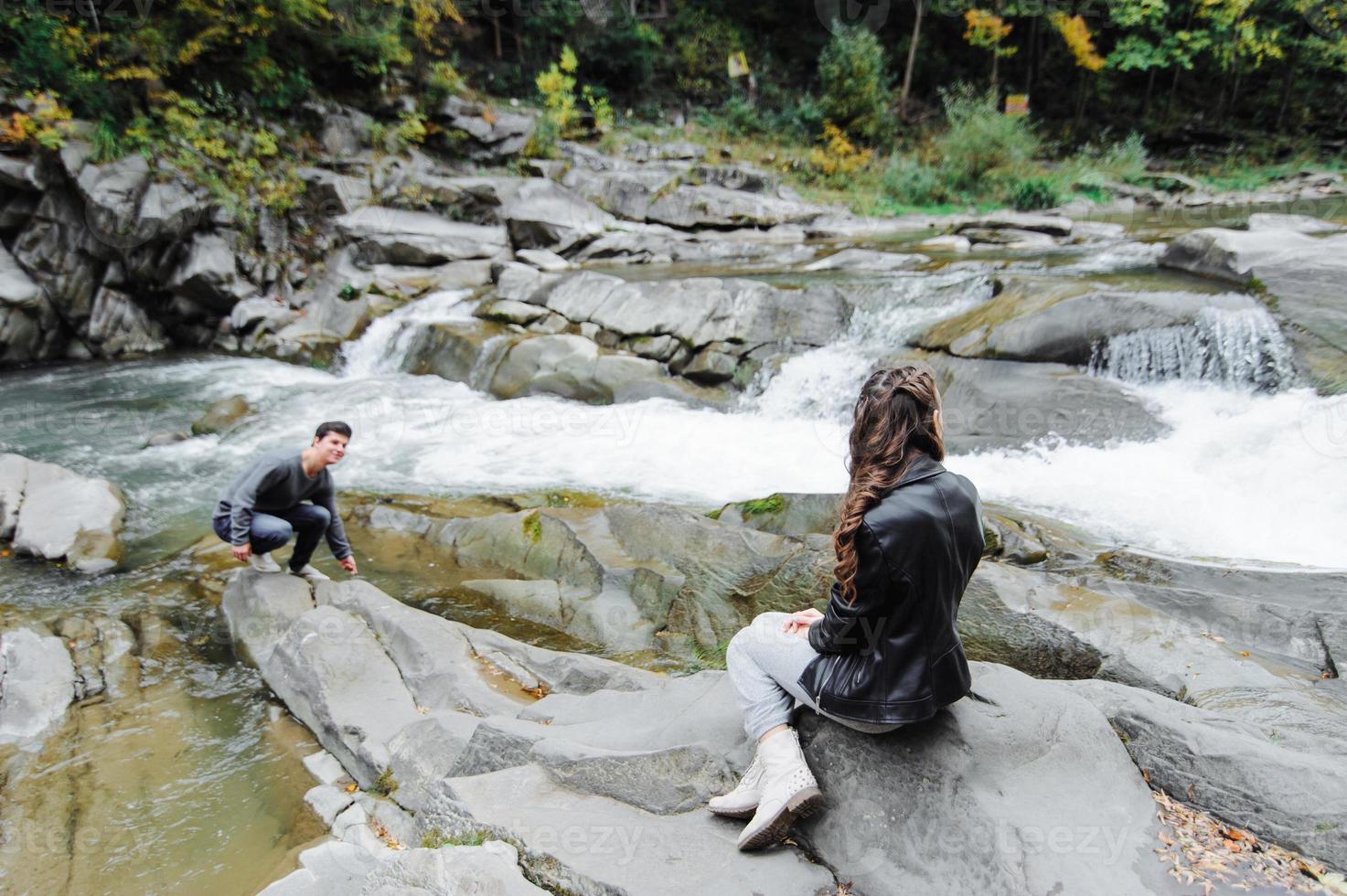 incredibly beautiful and lovely couple on the background of a mountain river photo