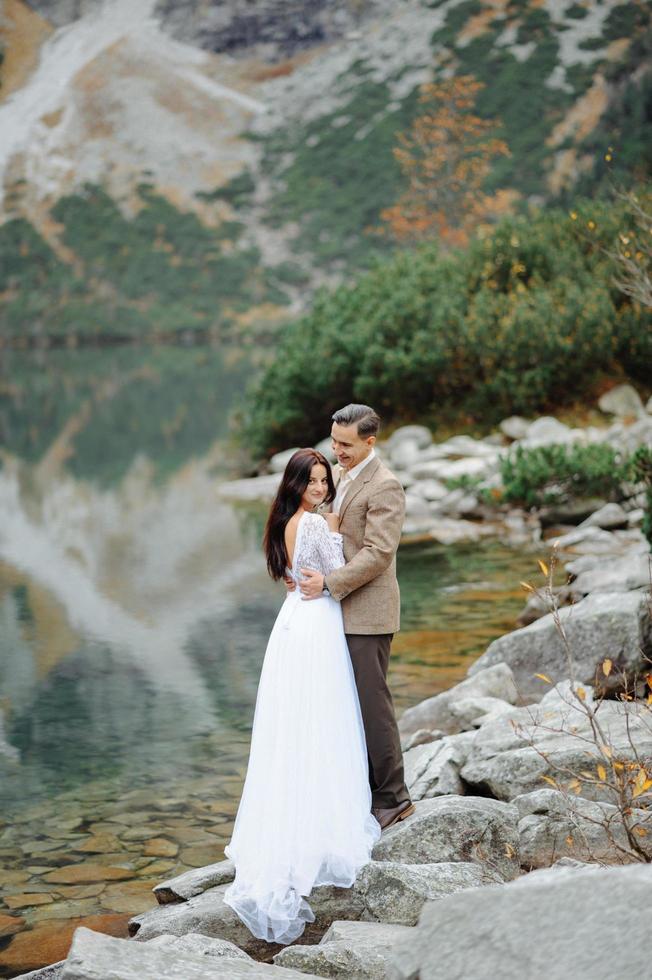 Loving couple on the background of the Sea-eye lake in Poland photo