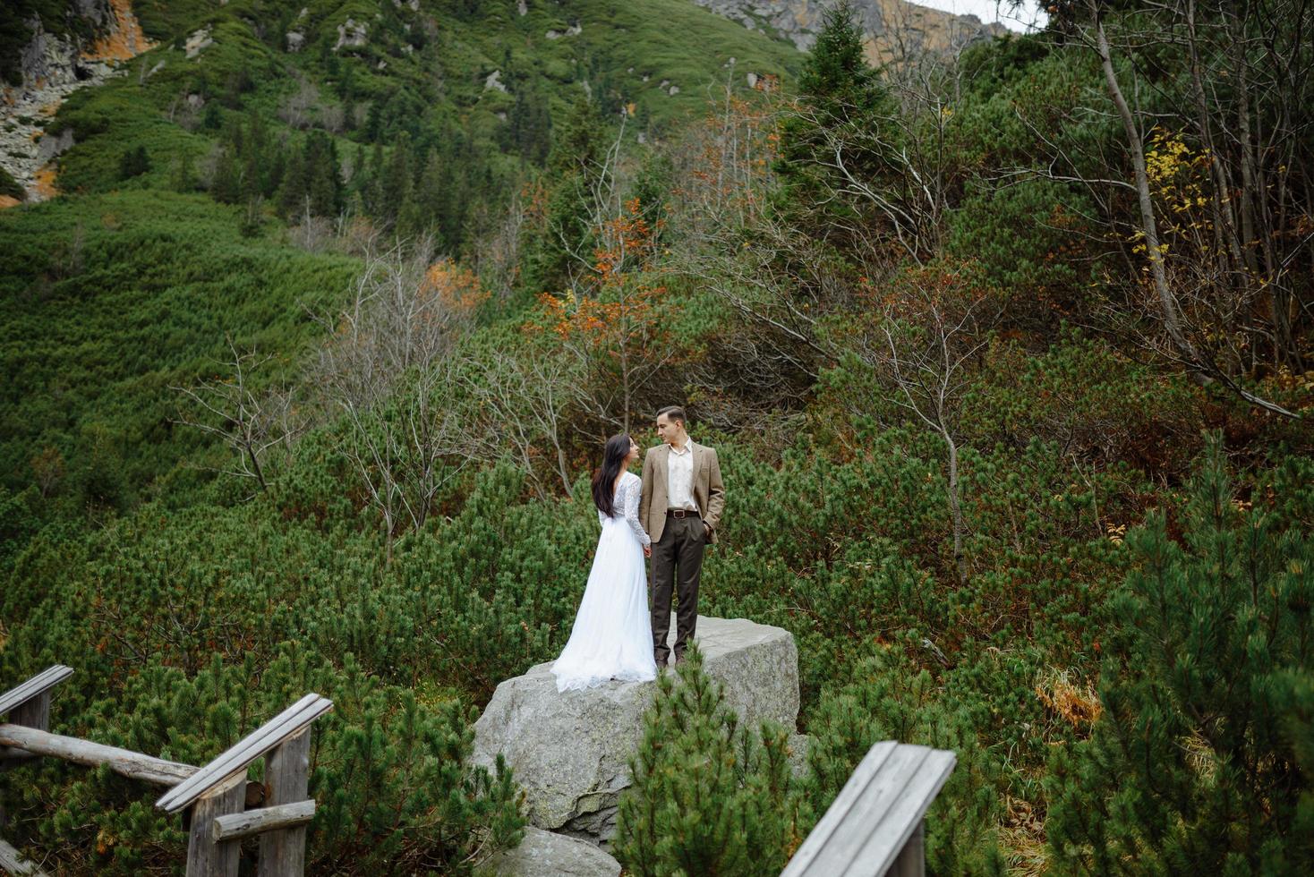 Beautiful couple walking among rocks photo