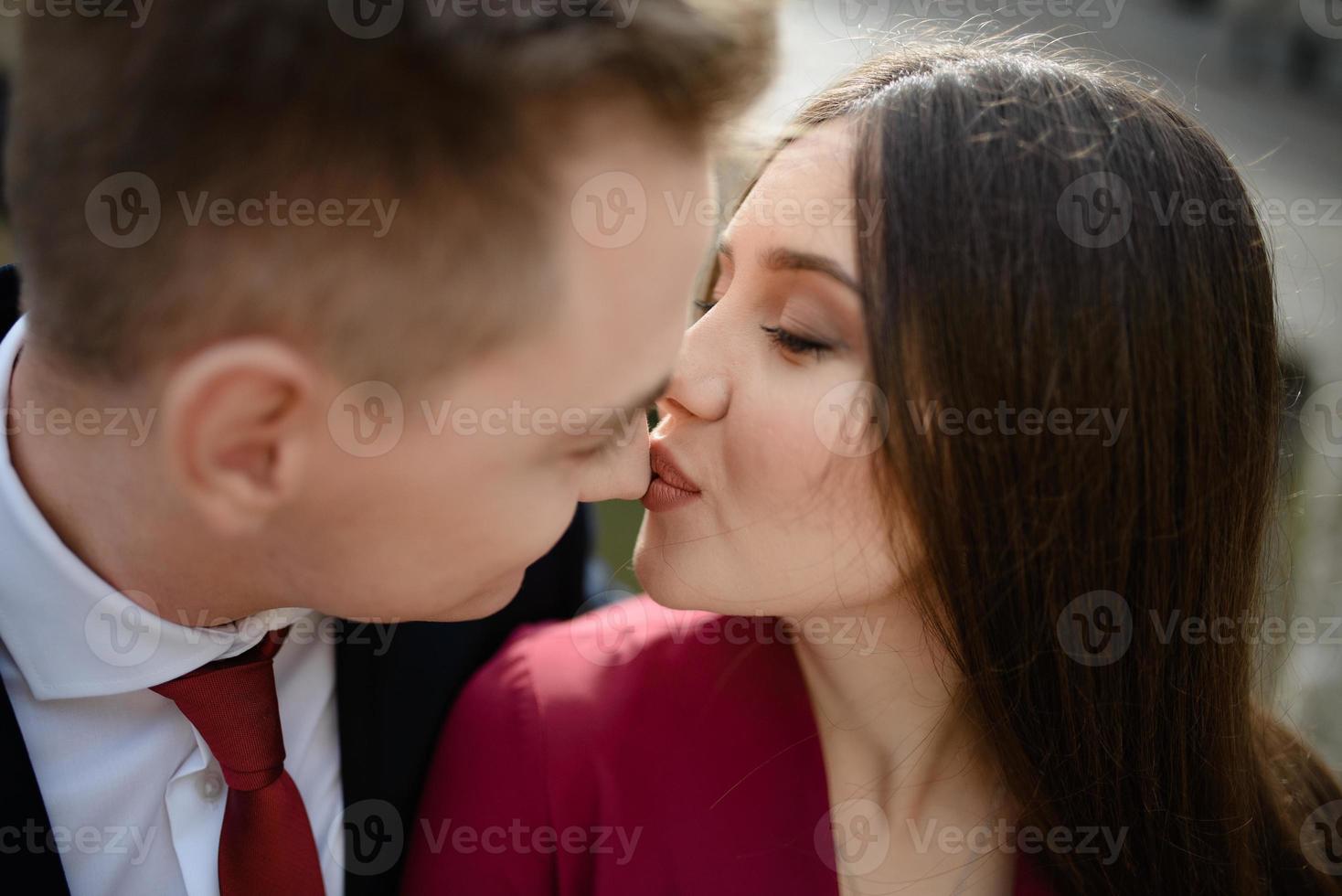 Sexy passion couple in love. Portrait of beautiful young man and woman dressed in classic clothes, studio shot over grey background photo