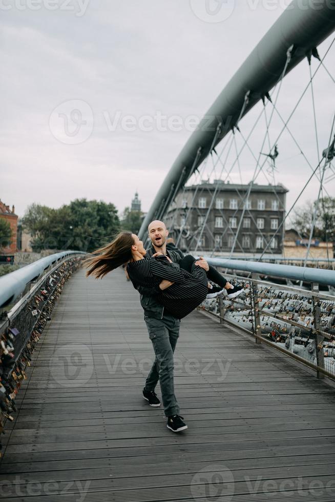 A love story. A man and a woman near the bridge. Love relationship. Autumn sunset. photo