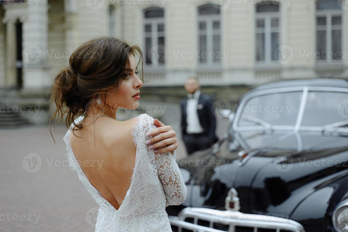 the groom in a gray suit and the bride in a gray dress look at each other, closeup portrait photo