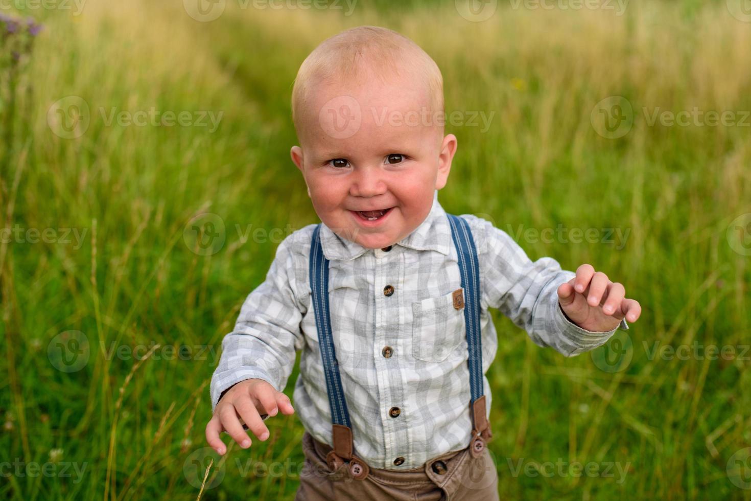 Father and mother lead their one-year-old son by the hand. photo