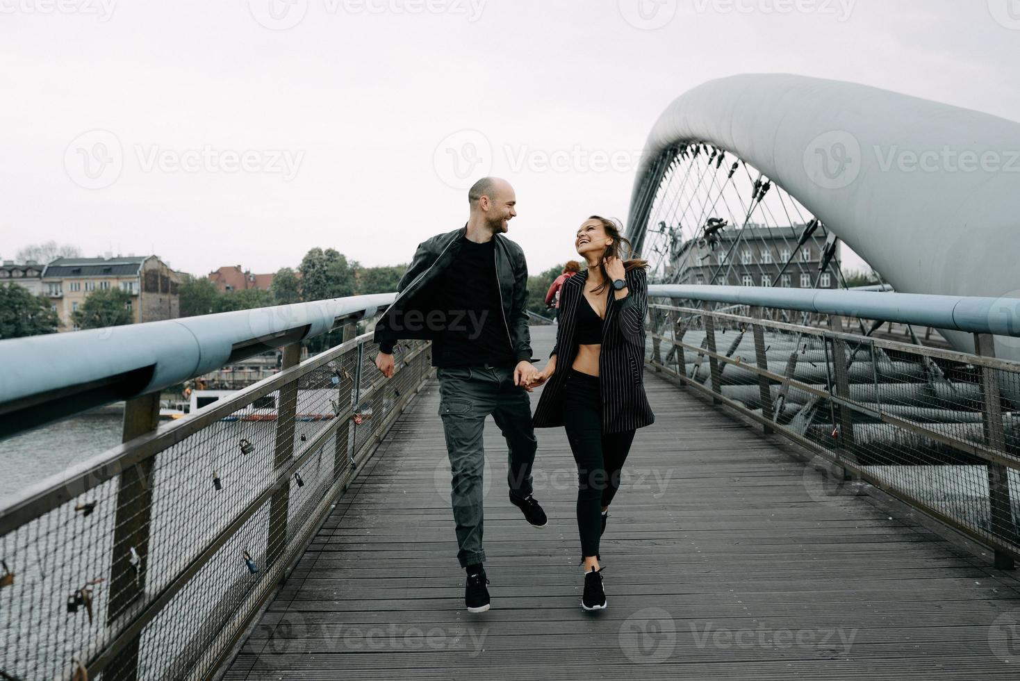 A love story. A man and a woman near the bridge. Love relationship. Autumn sunset. photo