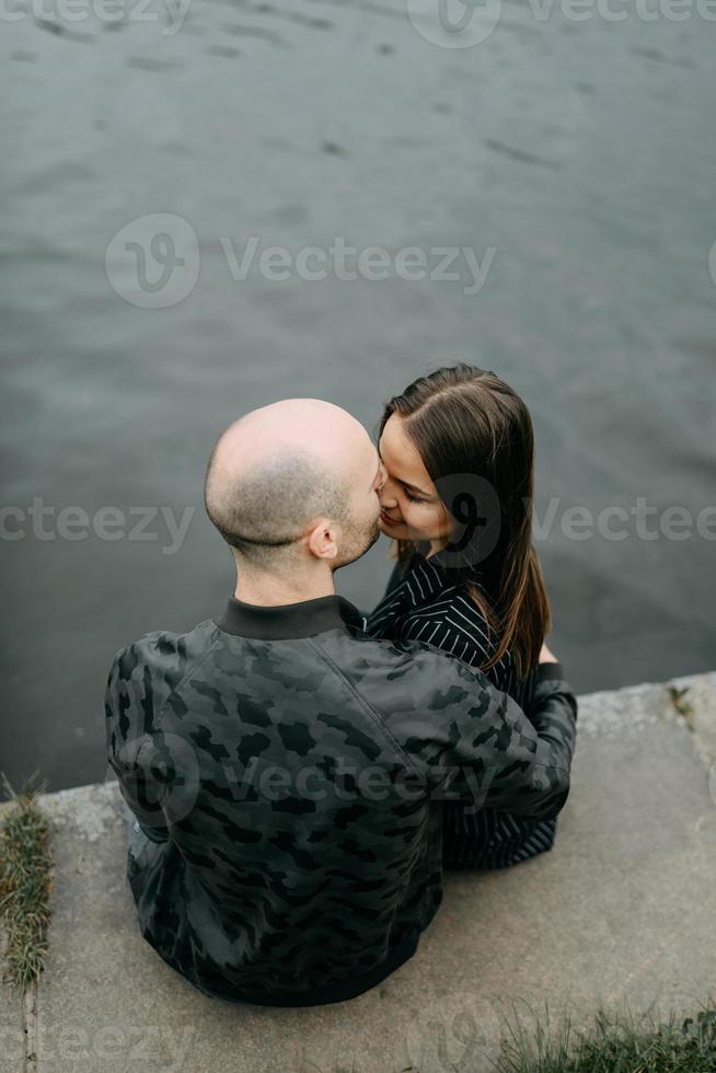 couple hugging on a pier photo
