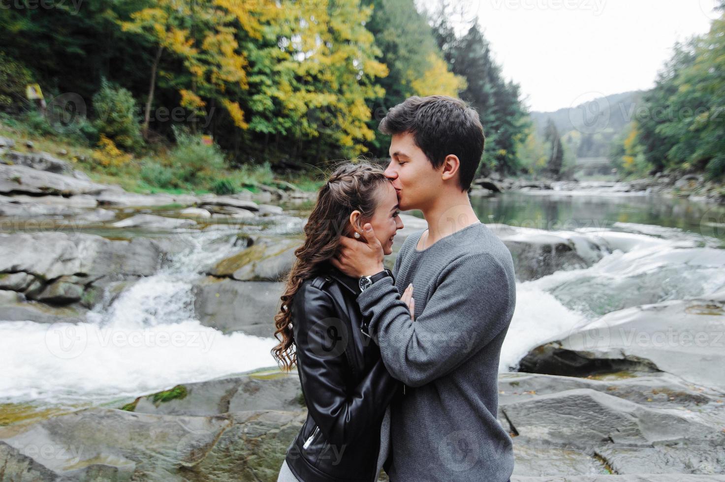 incredibly beautiful and lovely couple on the background of a mountain river photo