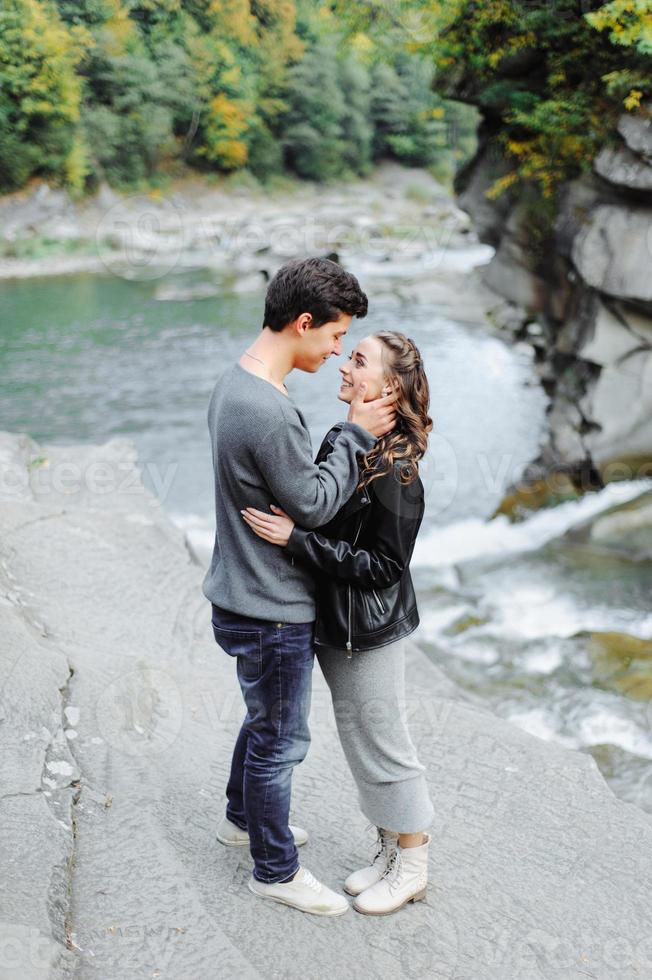 incredibly beautiful and lovely couple on the background of a mountain river photo