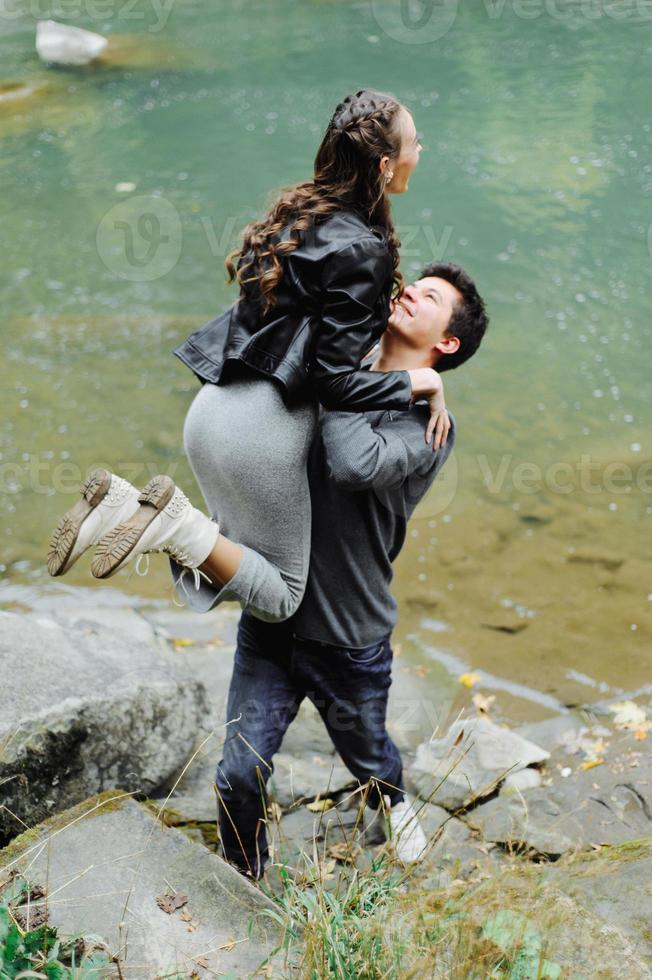 incredibly beautiful and lovely couple on the background of a mountain river photo