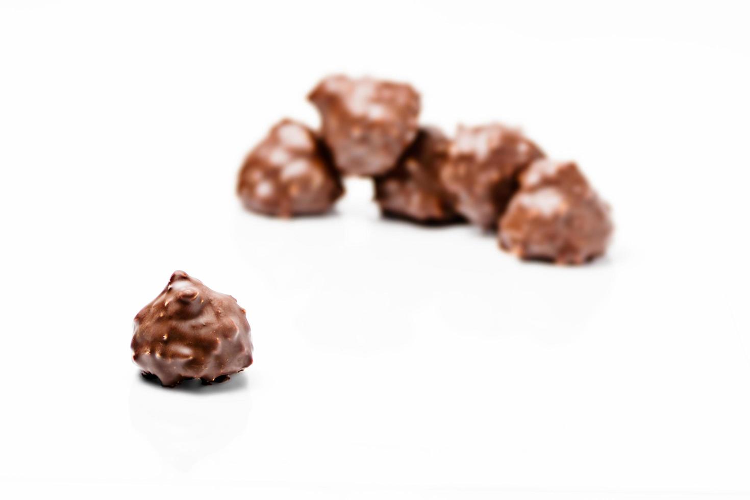 sweet dark chocolate with nuts on white background photo