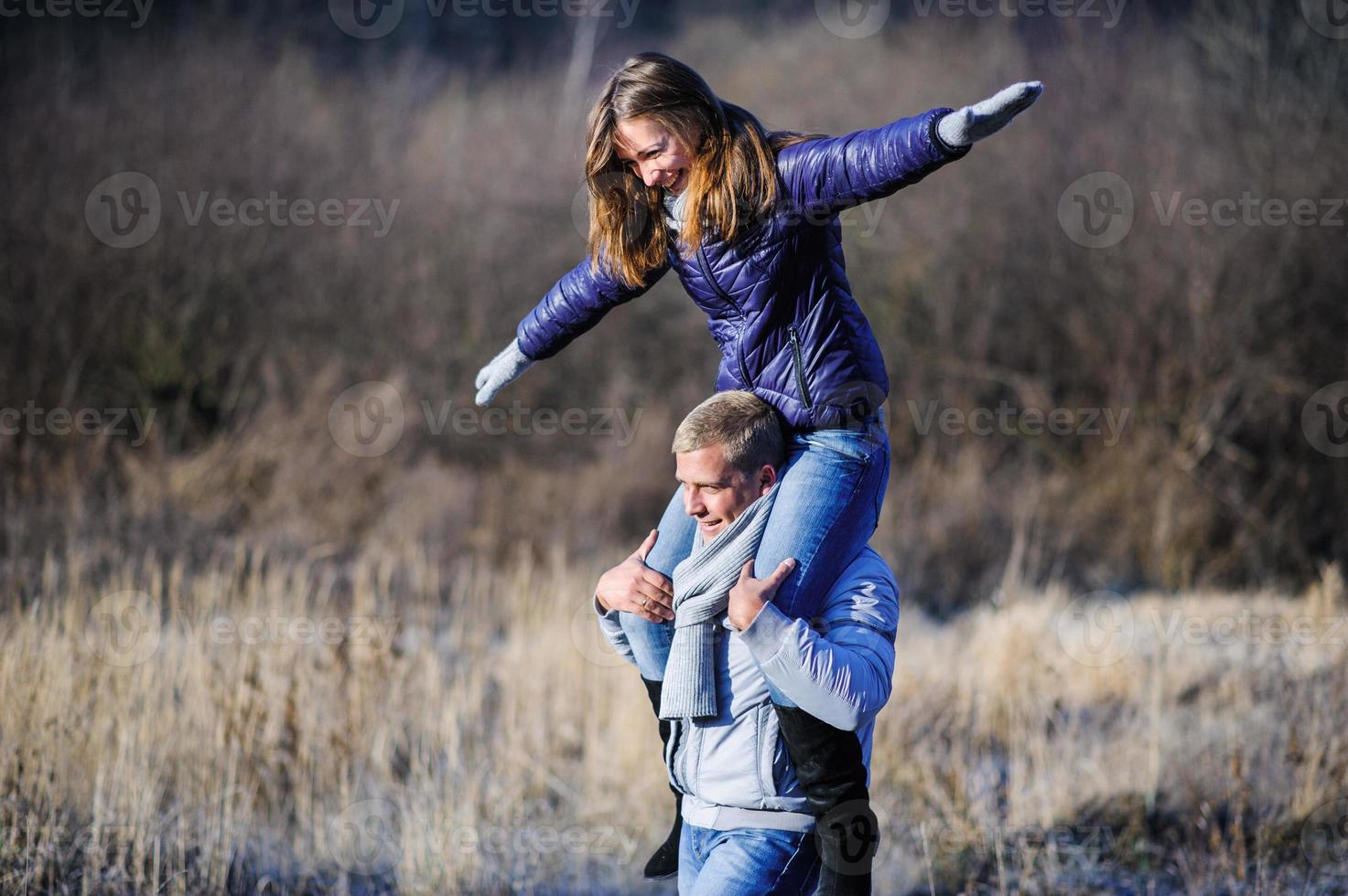 Couple having fun running down slope photo