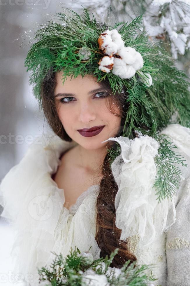 Portrait of a beautiful young bride with a bouquet. Winter wedding ceremony. photo