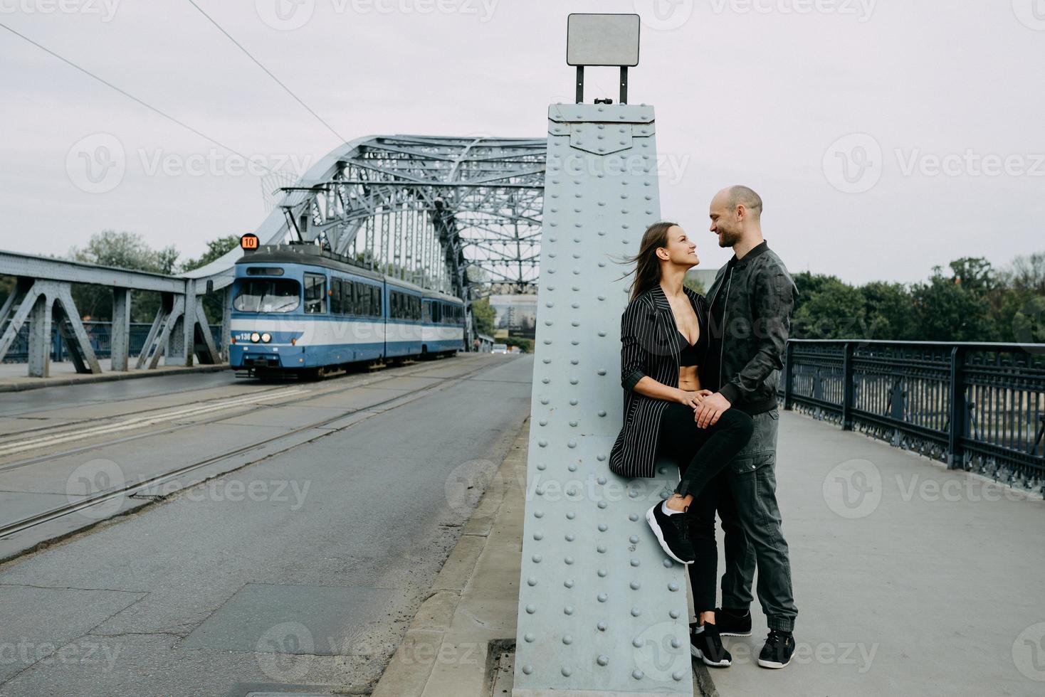 Portrait of a happy romantic couple with coffee walking outdoors in old european city photo