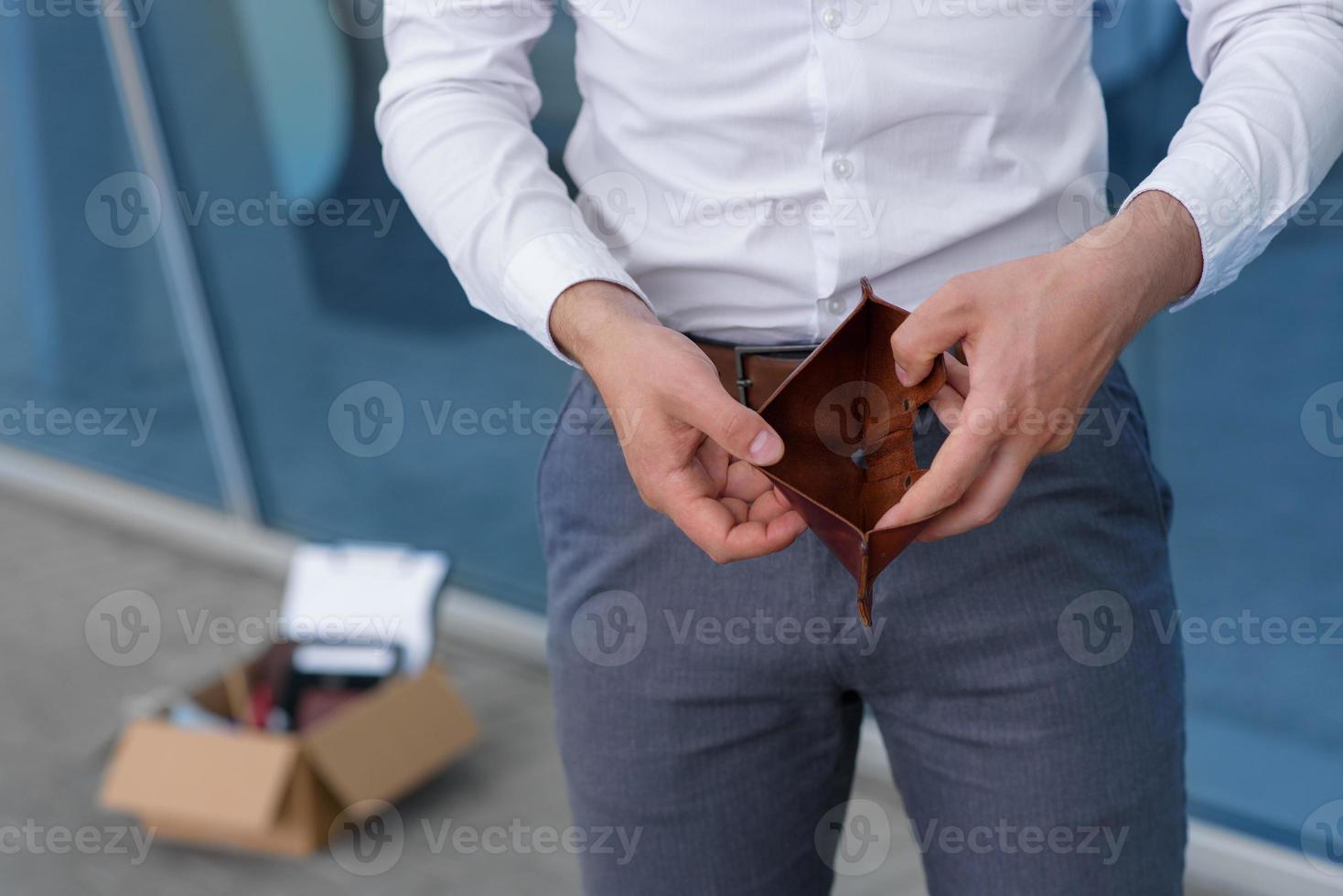A fired employee due to the crisis opens showing his empty wallet. photo