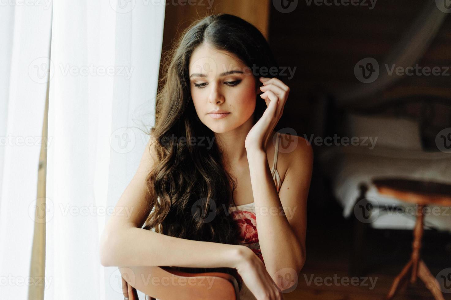 Beautiful girl in penuar lying on bed photo