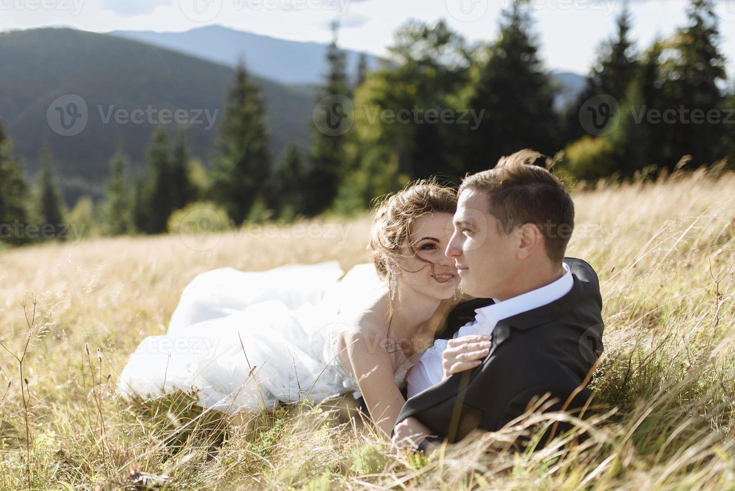 Beautiful bride and groom at the mountains photo