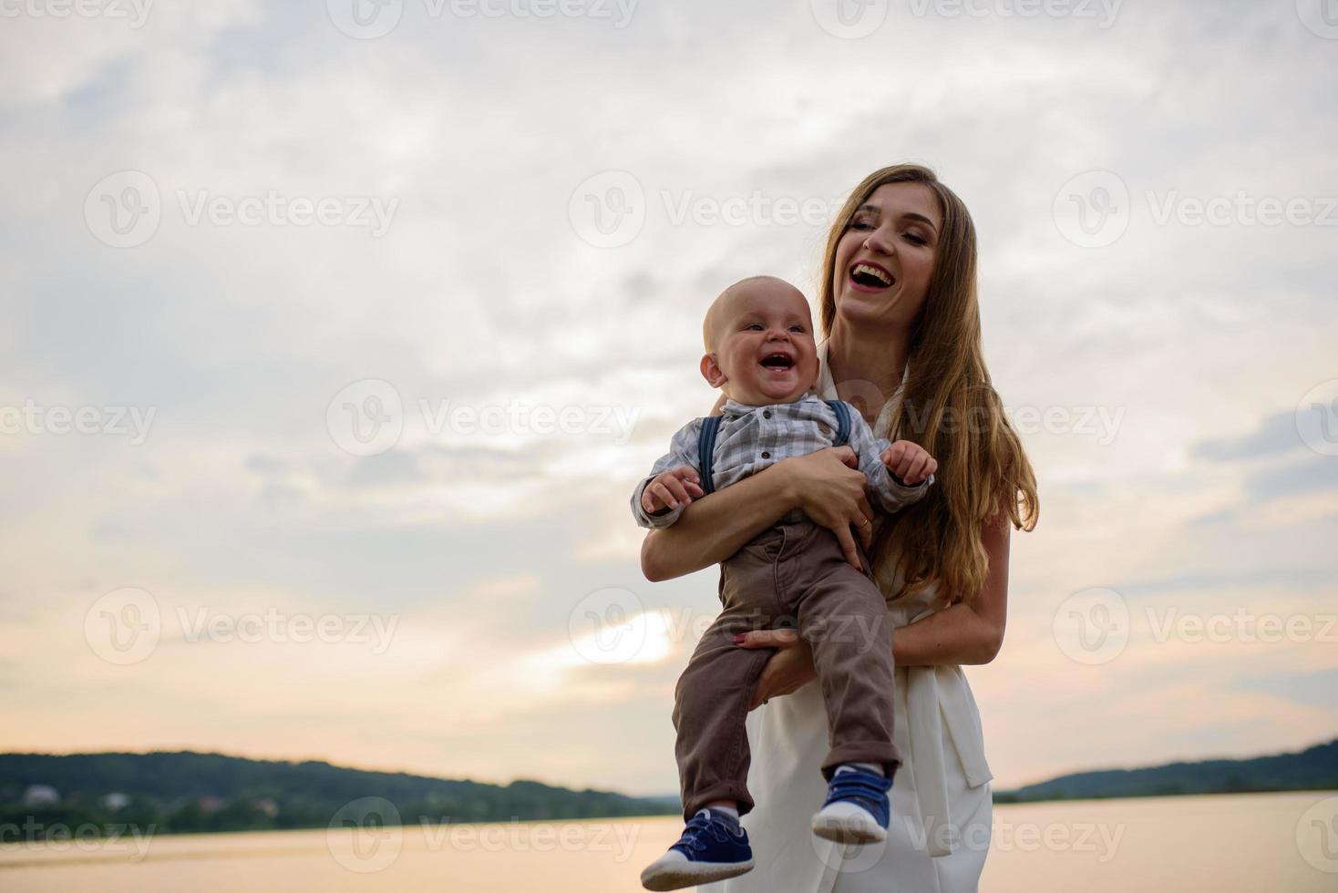 Father and mother lead their one-year-old son by the hand. photo