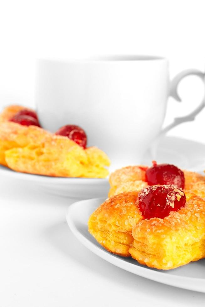 cup of tea on a saucer and cake photo