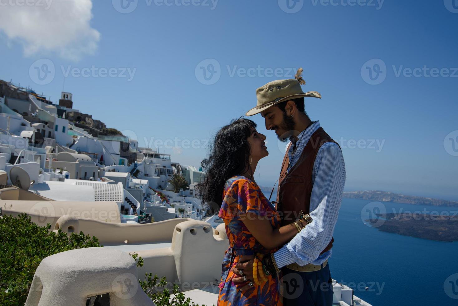 young couple honeymoon on the most romantic island Santorini, Greece. Sunset in the city Oia photo