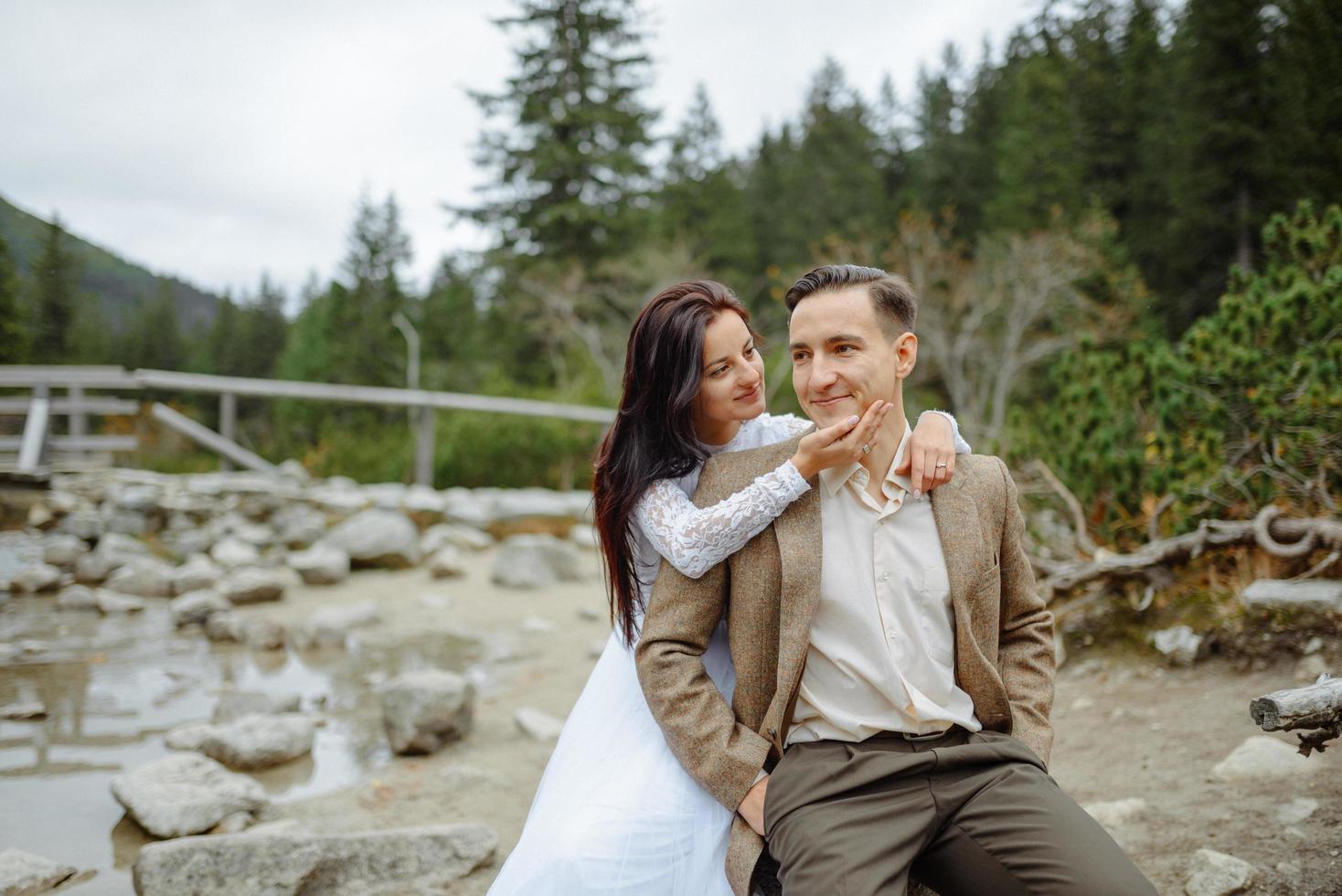 Beautiful couple walking among rocks photo