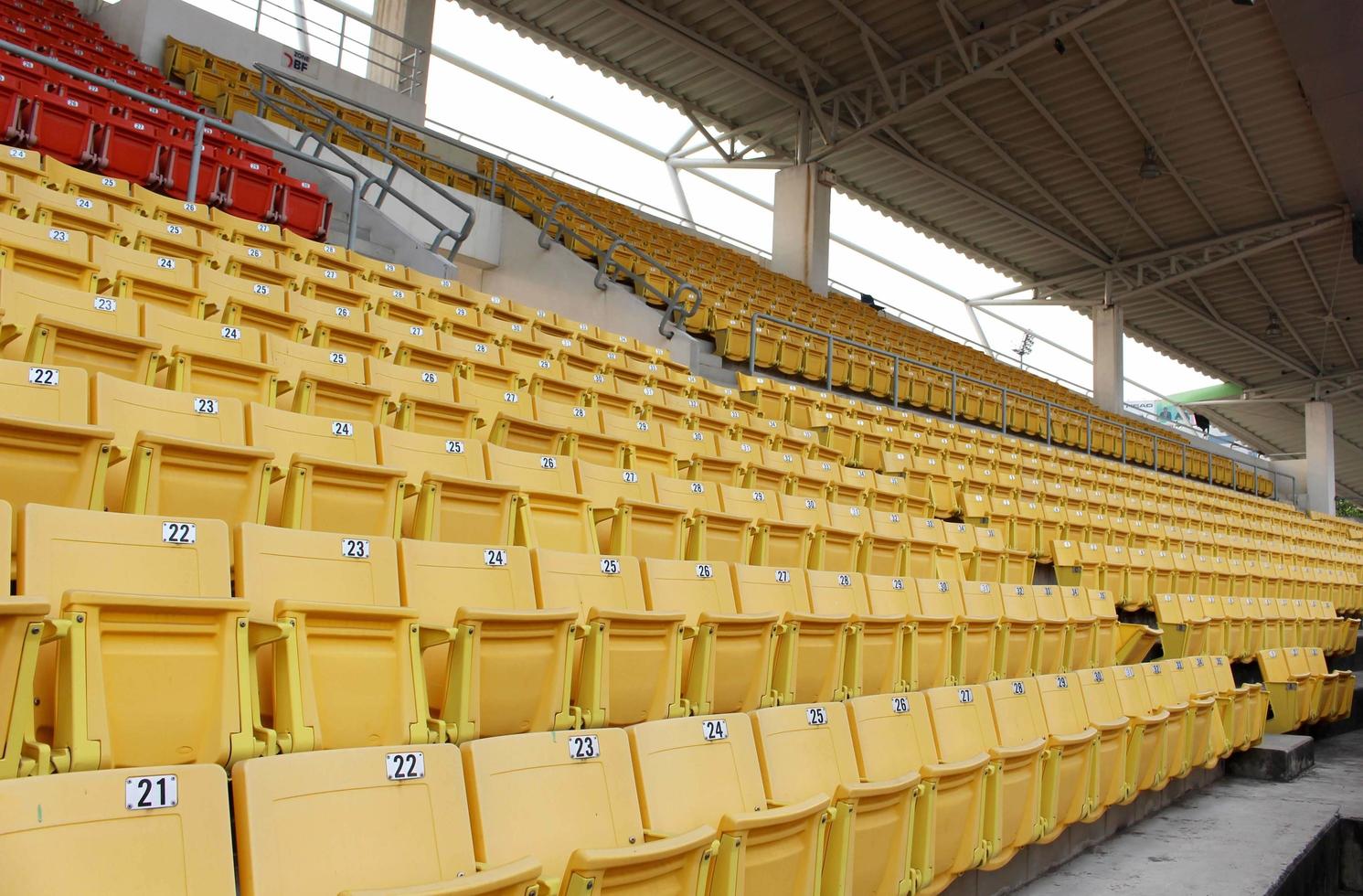 Yellow seats on the grandstand in the stadium photo