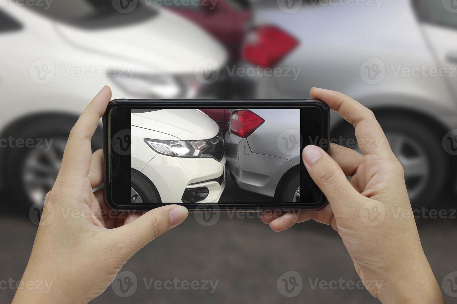 Hand holding smart phone take a photo at The scene of a car crash, car accident for insurance