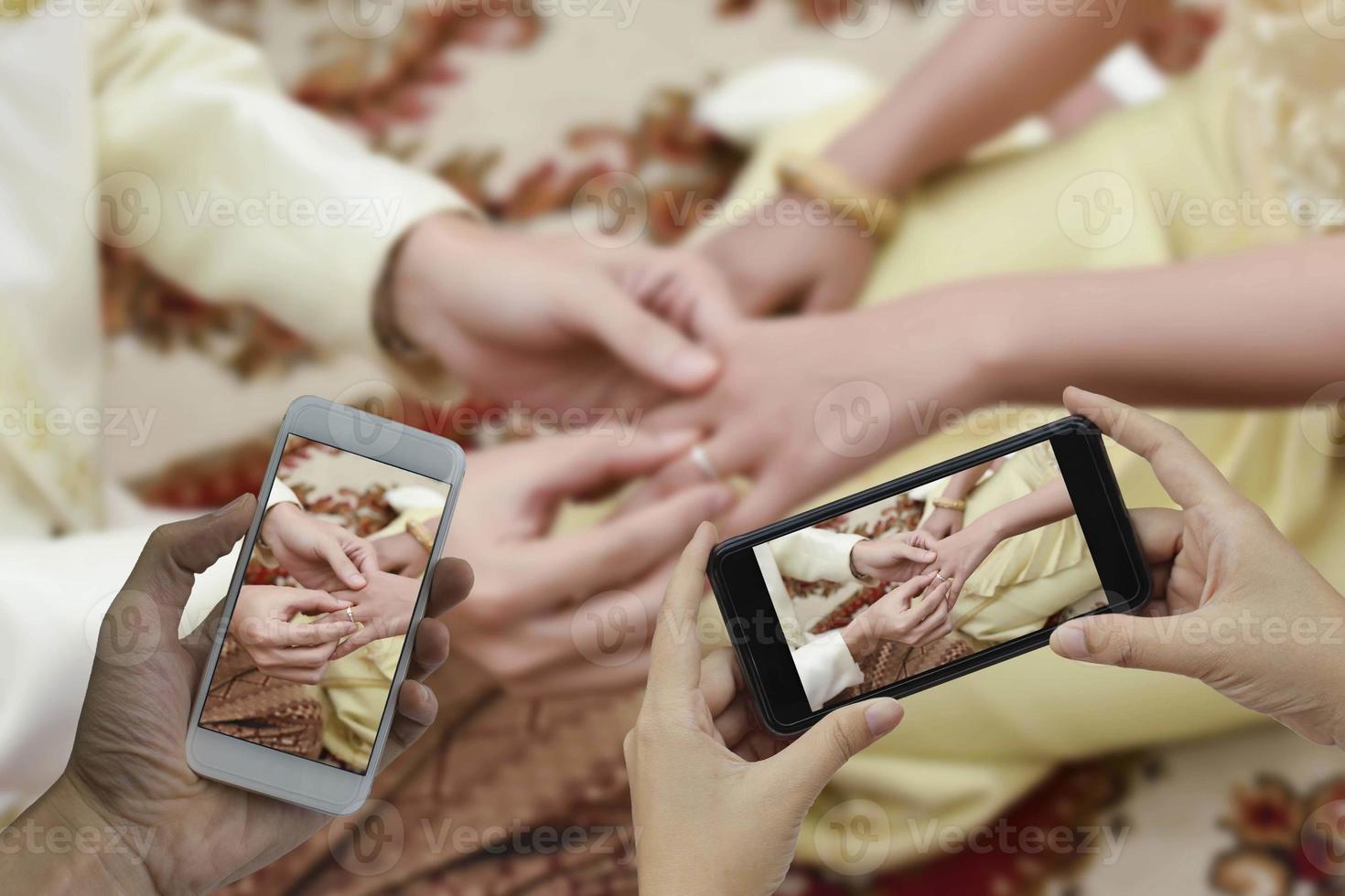 Hand holding smart phone take a photo at blurred Get married background