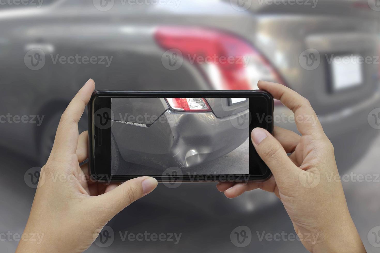 Hand holding smart phone take a photo at The scene of a car crash, car accident for insurance