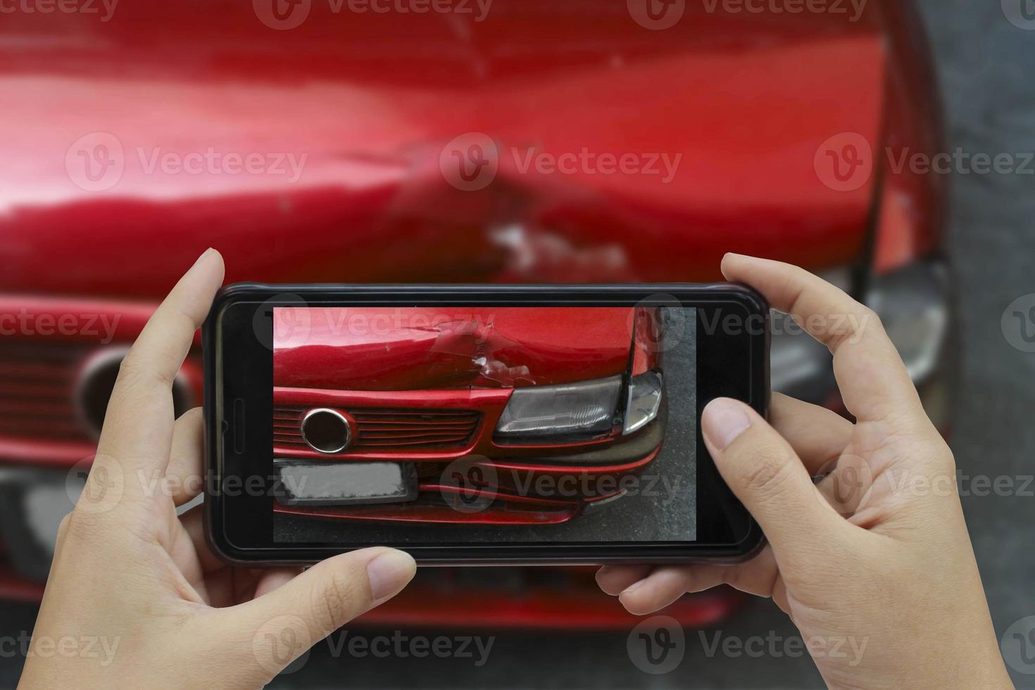 Hand holding smart phone take a photo at The scene of a car crash, car accident for insurance