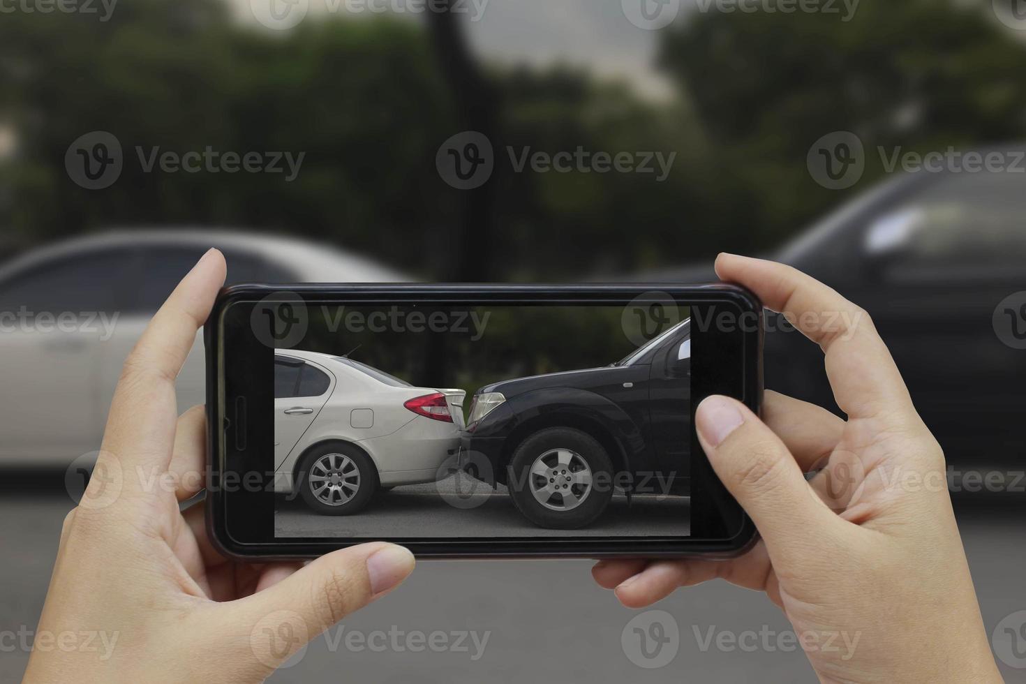 Hand holding smart phone take a photo at The scene of a car crash, car accident for insurance