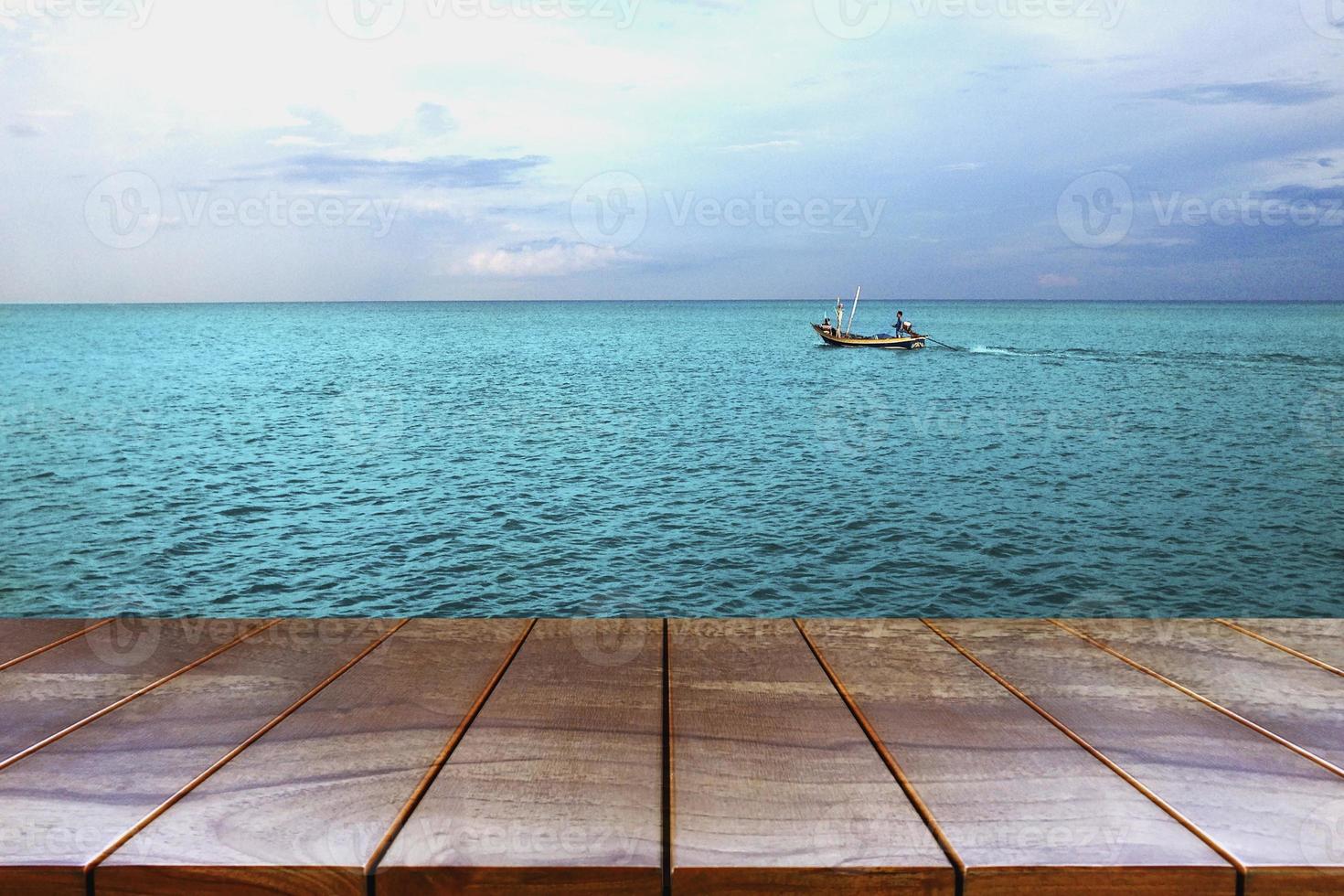 Empty wooden table space platform and Boats on the sea and sky background for product display montage , Wood table for product placement photo