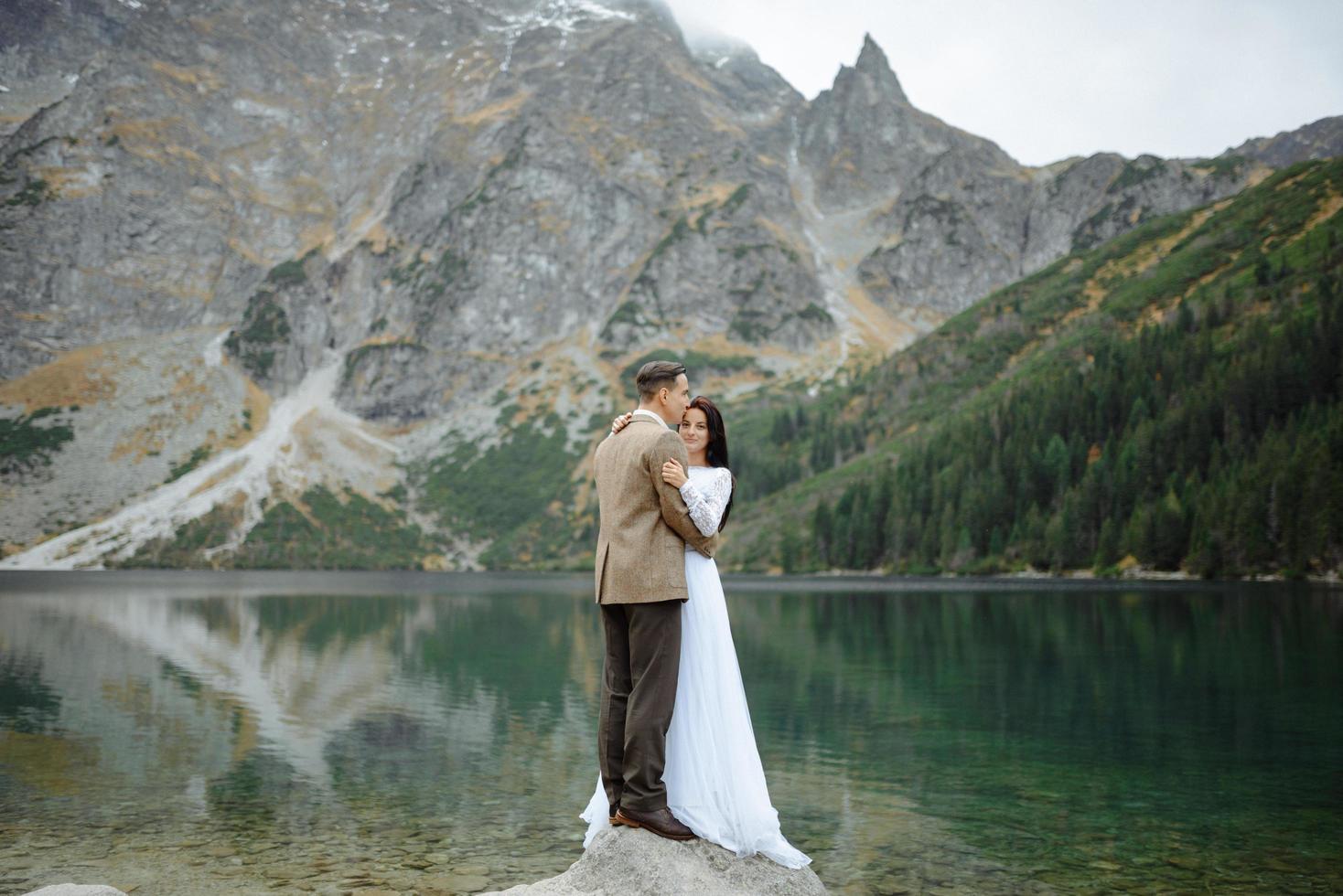 Loving couple on the background of the Sea-eye lake in Poland photo