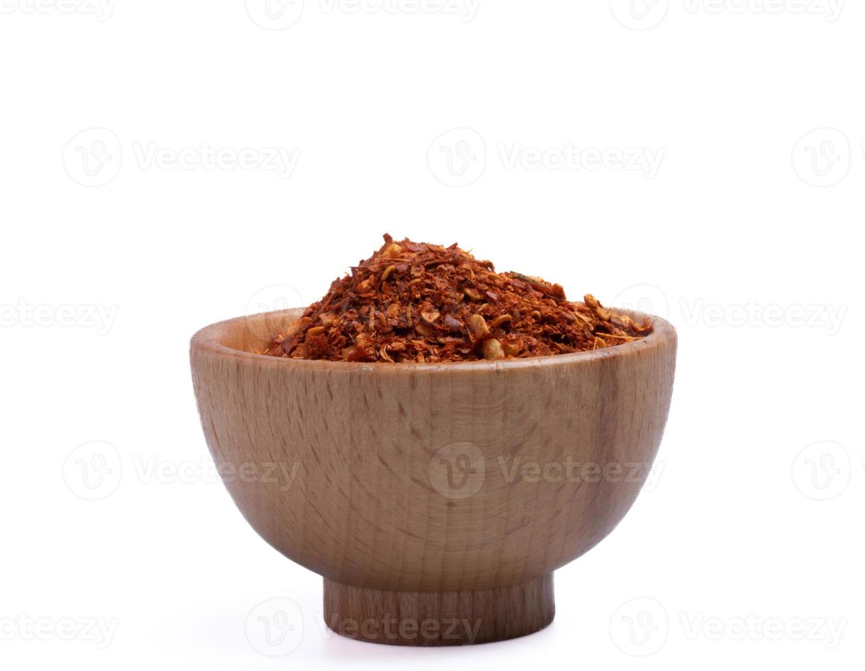 dried chili peppers in a wooden cup on a white background photo