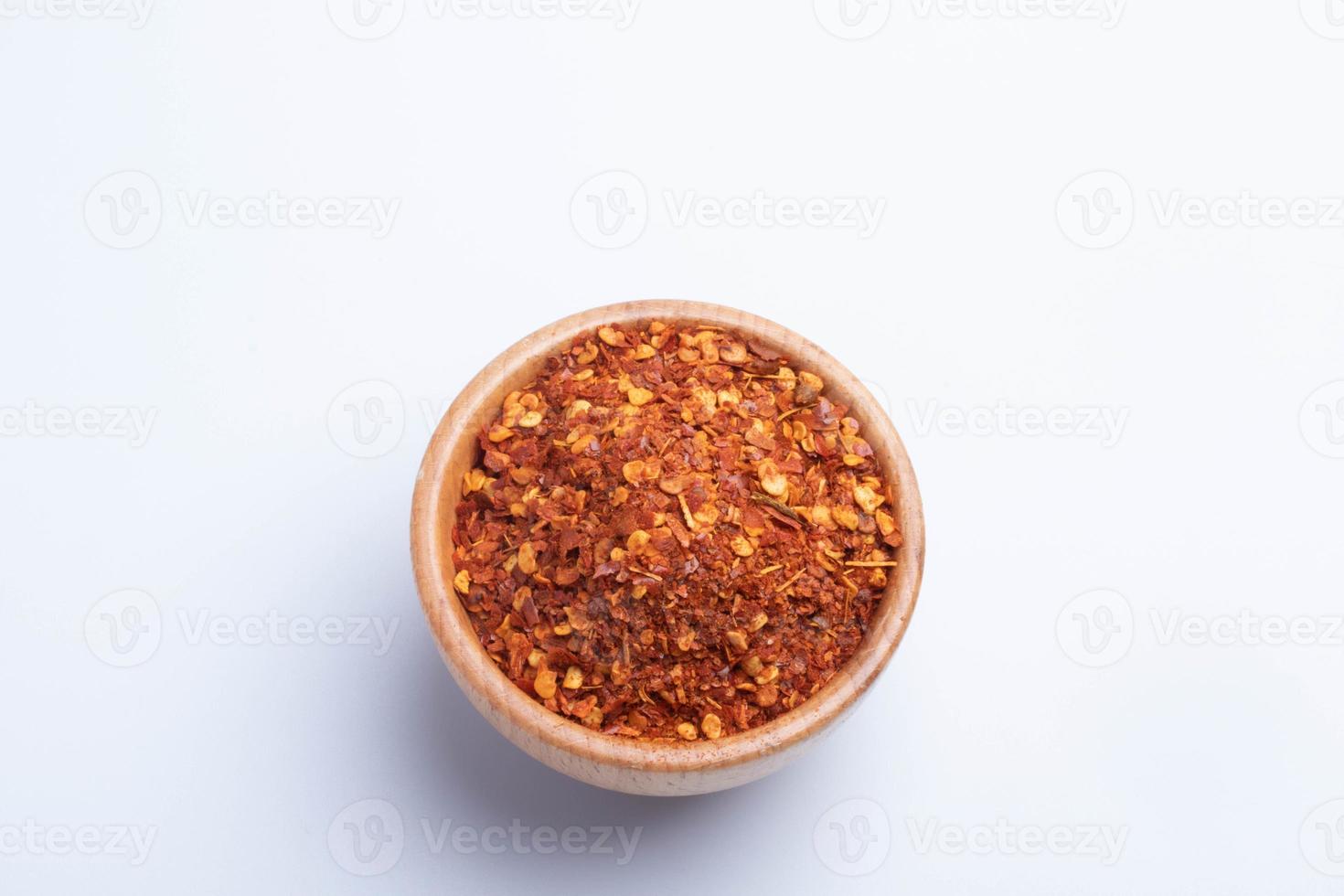 dried chili peppers in a wooden cup on a white background photo