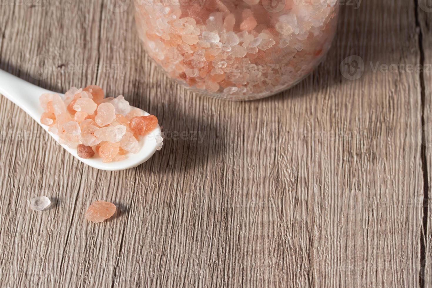 Himalayan pink salt in a white spoon photo