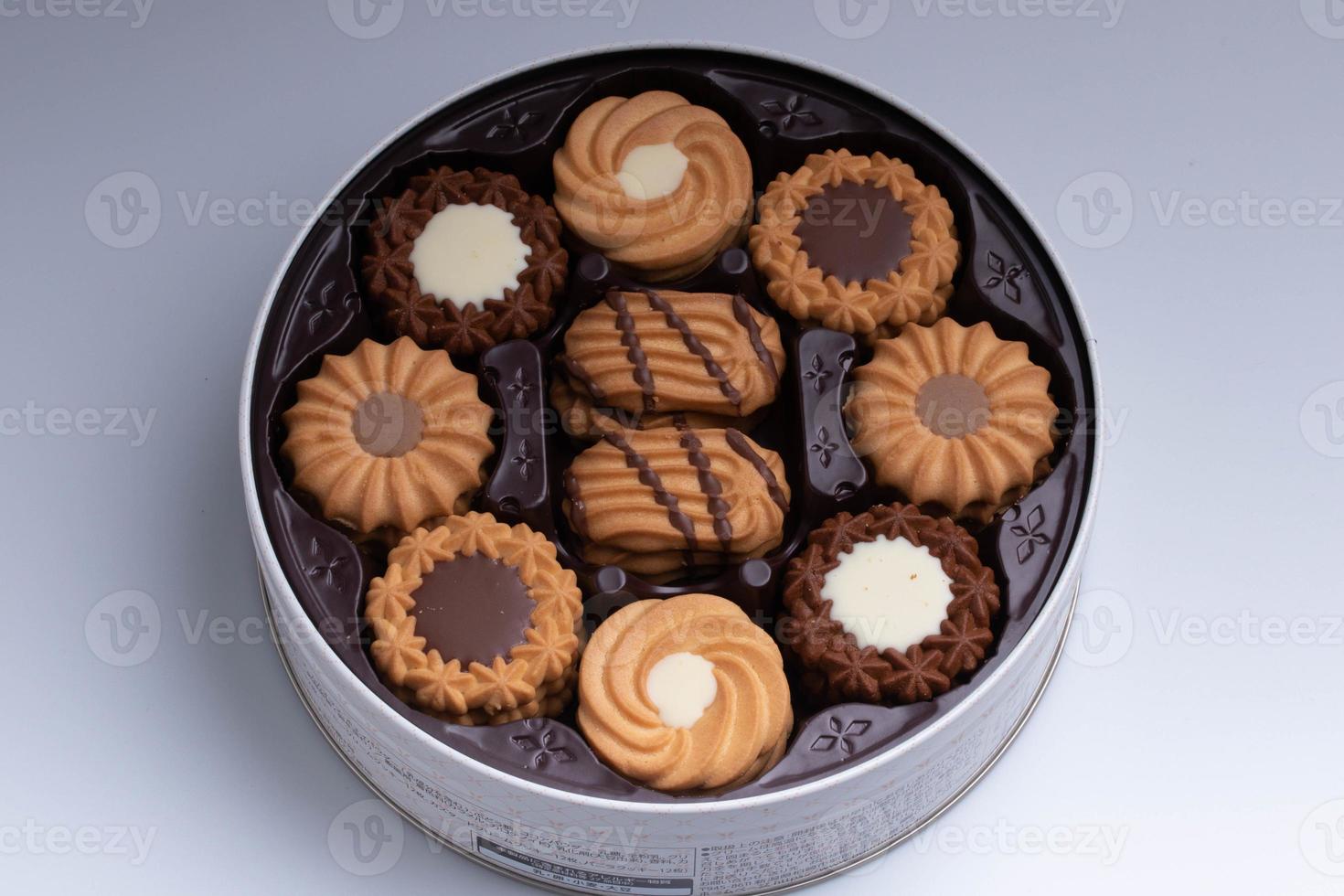 Assorted cookies set in a round box on white background for the new year. photo