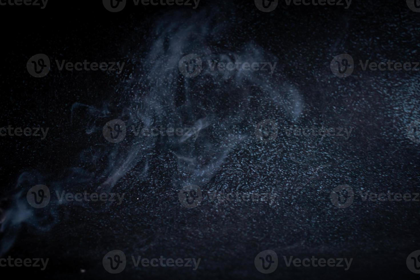 incense and smoke on black background photo
