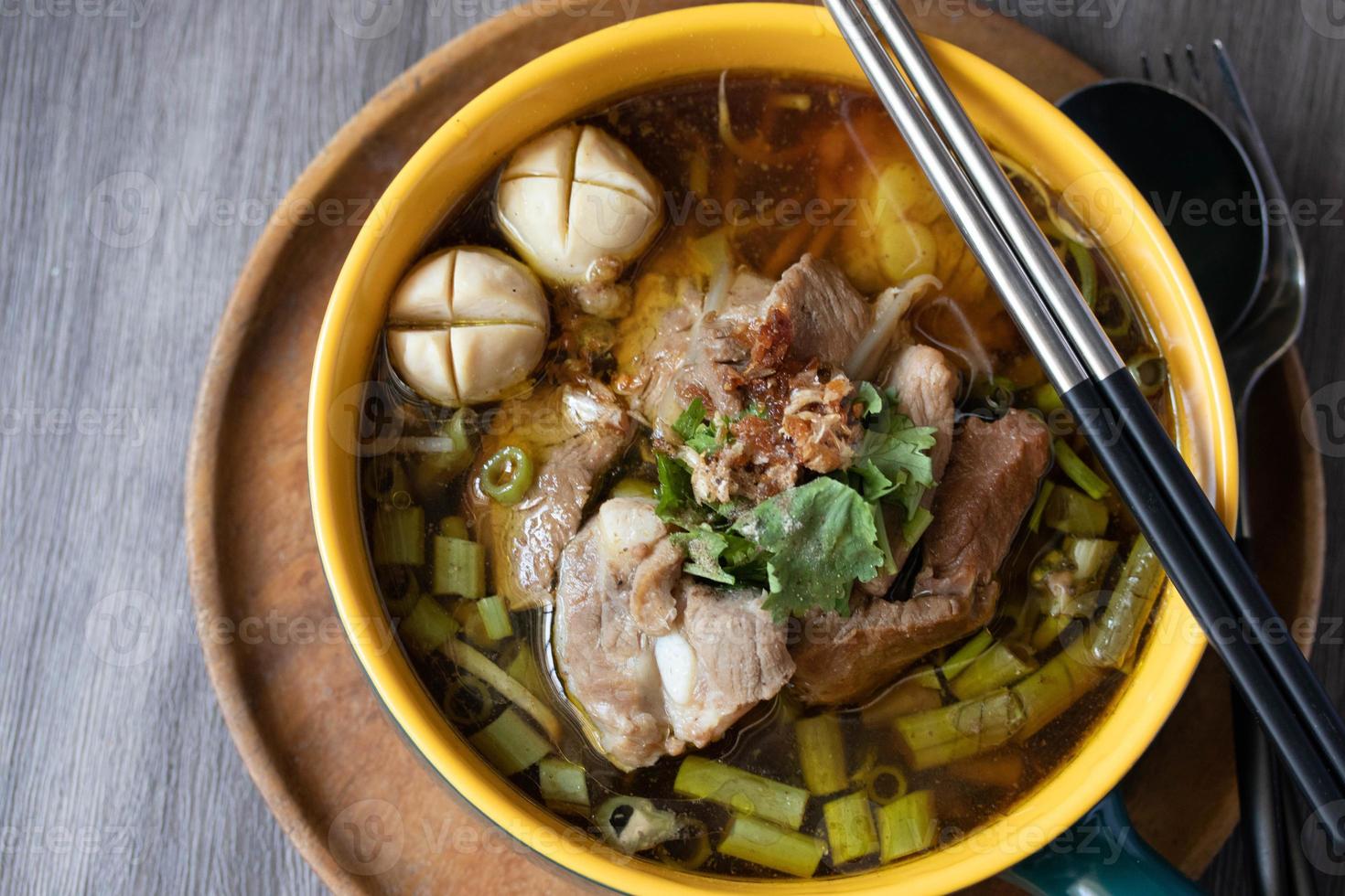 Braised pork kaolao with morning glory and sprouts, local Thai food photo